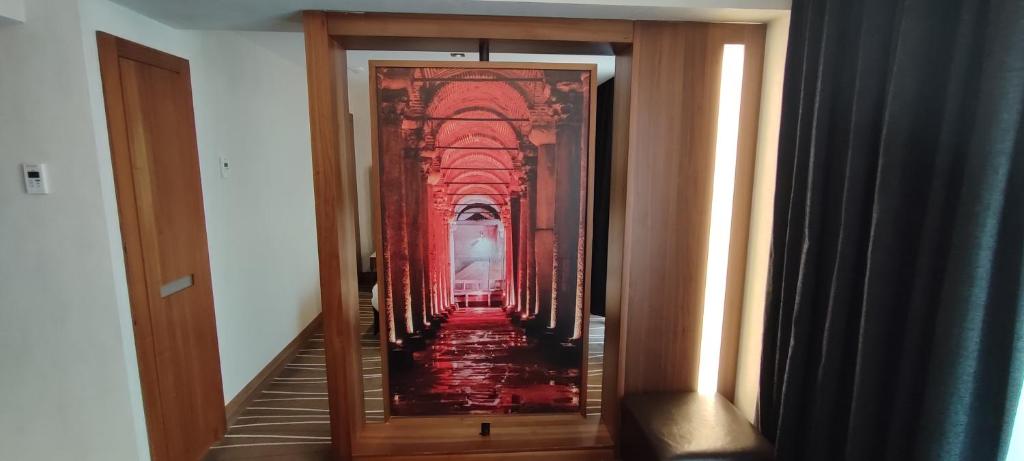 a hallway with a painting on the door of a building at Cihangir Hotel Bosphorus in Istanbul