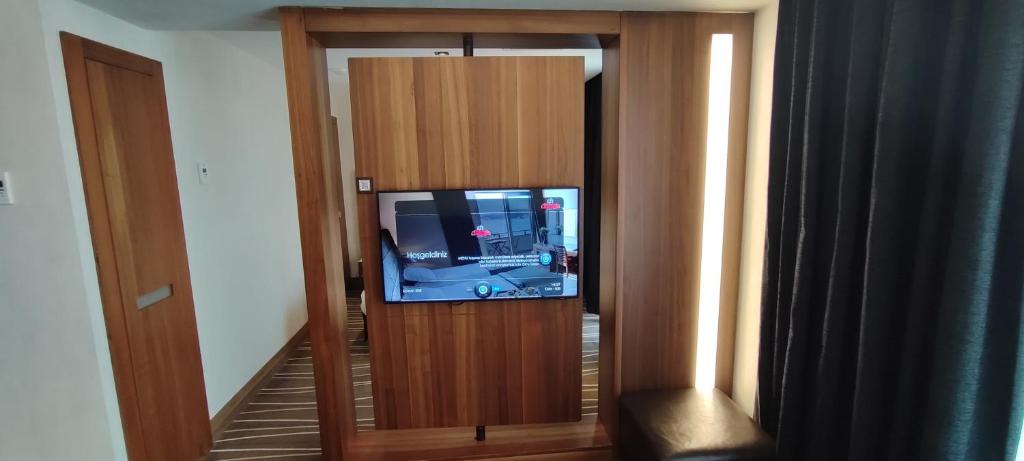 a television in a wooden cabinet with a tv in it at Cihangir Hotel Bosphorus in Istanbul