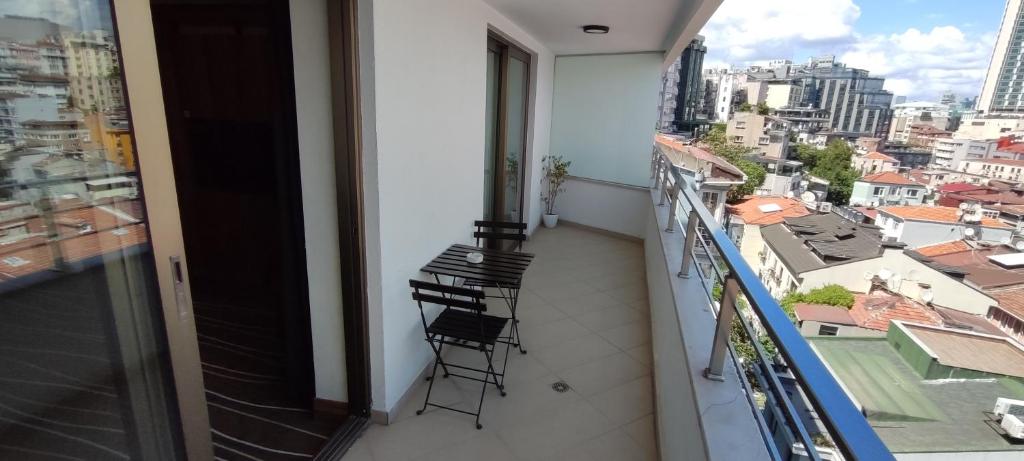 a balcony with two chairs and a view of a city at Cihangir Hotel Bosphorus in Istanbul