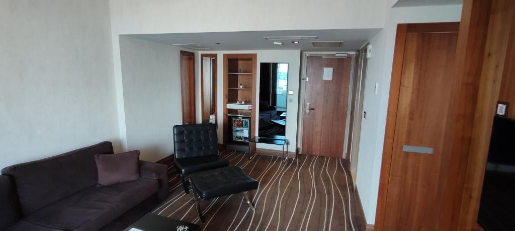 a living room with a couch and a chair at Cihangir Hotel Bosphorus in Istanbul