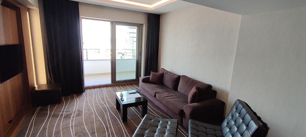 a living room with a couch and a window at Cihangir Hotel Bosphorus in Istanbul