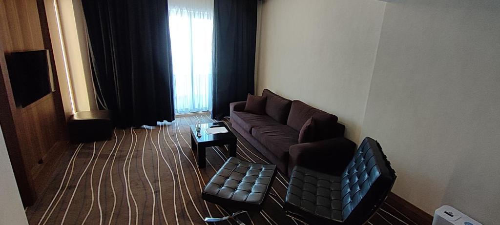 a living room with a couch and a chair at Cihangir Hotel Bosphorus in Istanbul