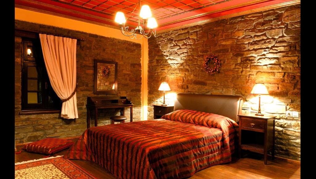 A bed or beds in a room at Adrasteia Guesthouse