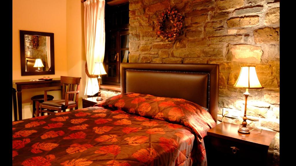A bed or beds in a room at Adrasteia Guesthouse
