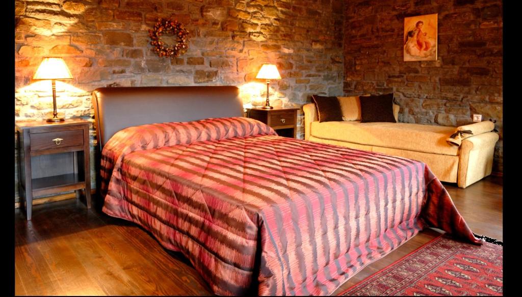 A bed or beds in a room at Adrasteia Guesthouse