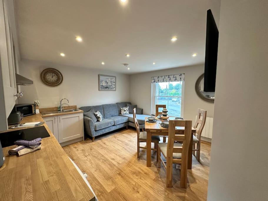 a kitchen and living room with a table and a couch at The Top Deck, Wells-next-the-Sea in Wells next the Sea