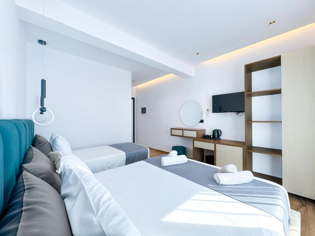 a room with two beds and a couch at Zace Studios in Ksamil