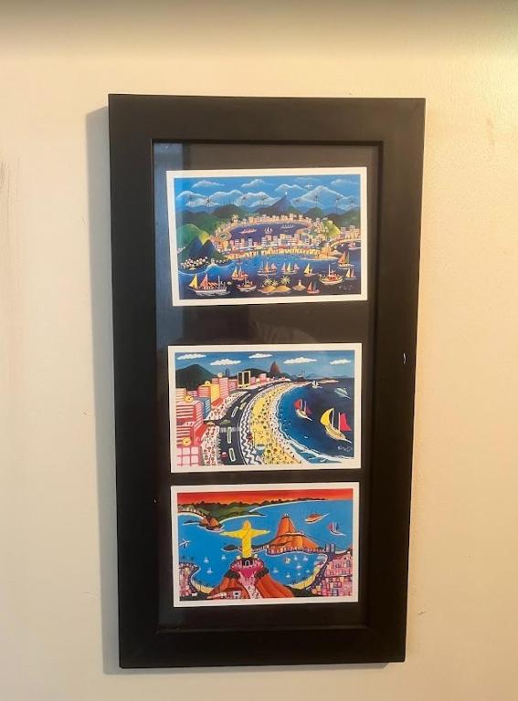 three pictures in a frame hanging on a wall at Studio no Largo da Carioca - Rio de Janeiro in Rio de Janeiro