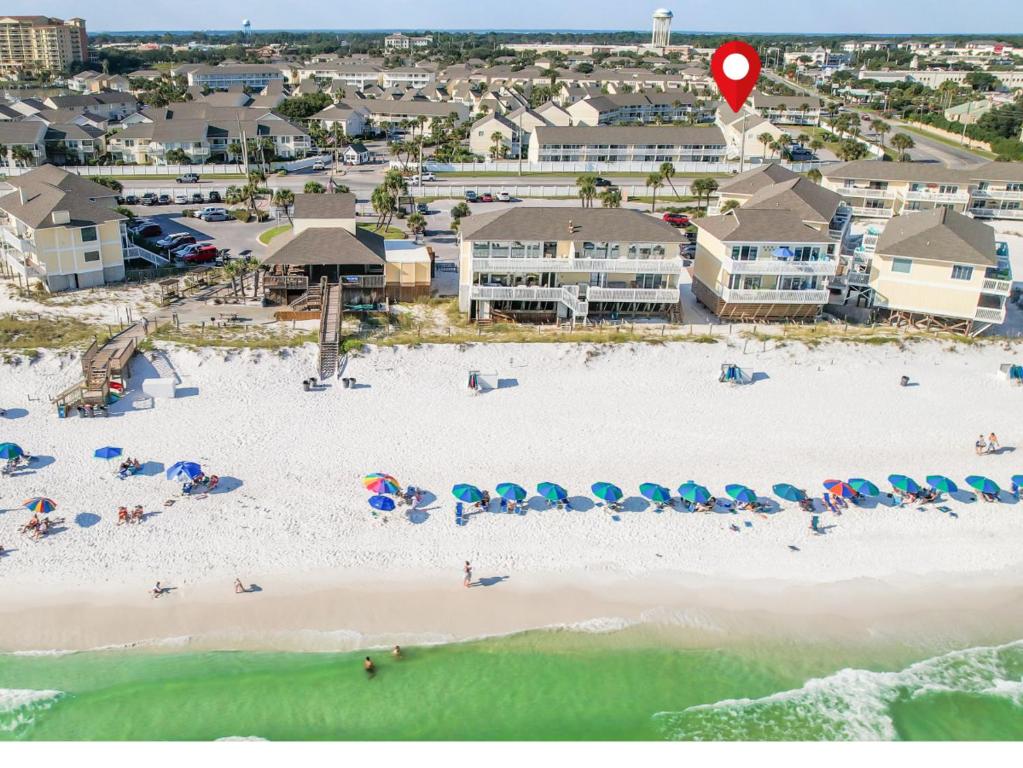 an aerial view of a beach with chairs and umbrellas at Sandpiper Cove Unit 8125 Updated Studio In Destin FL in Destin