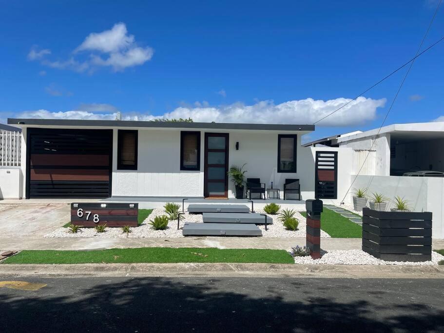 a white house with a bench in front of it at Casa Valentina Dreamy Beach Lakeview House in Punta Santiago