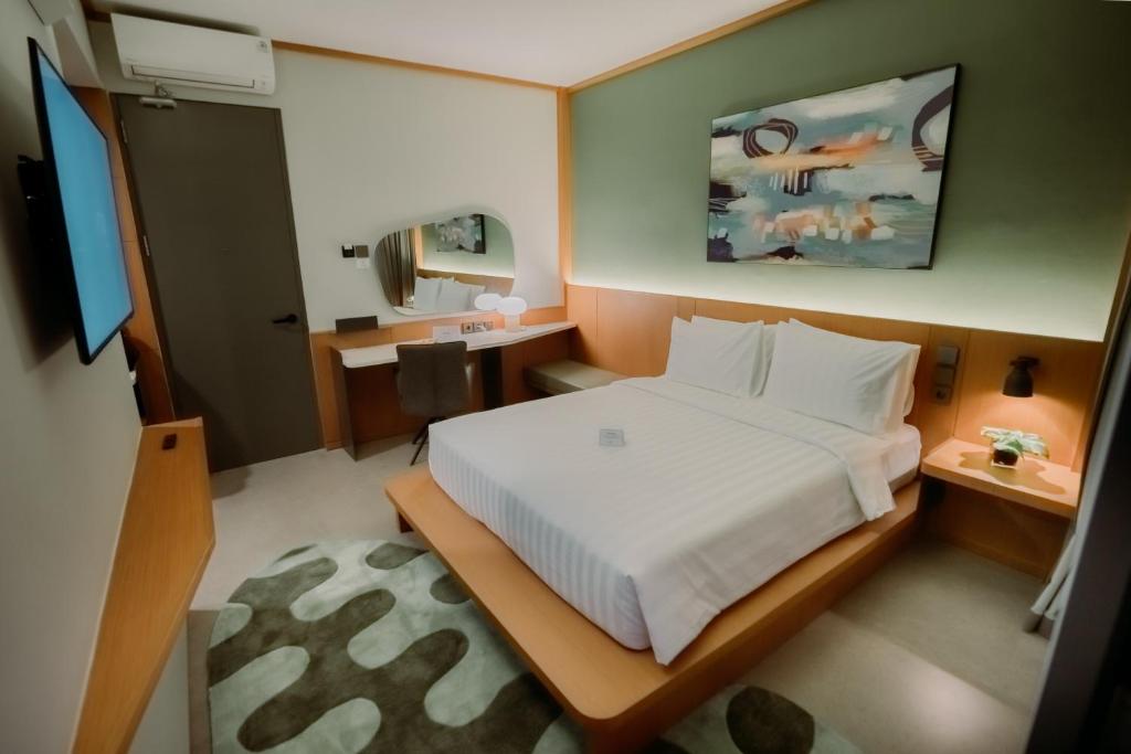 Postel nebo postele na pokoji v ubytování Jiro Hotel