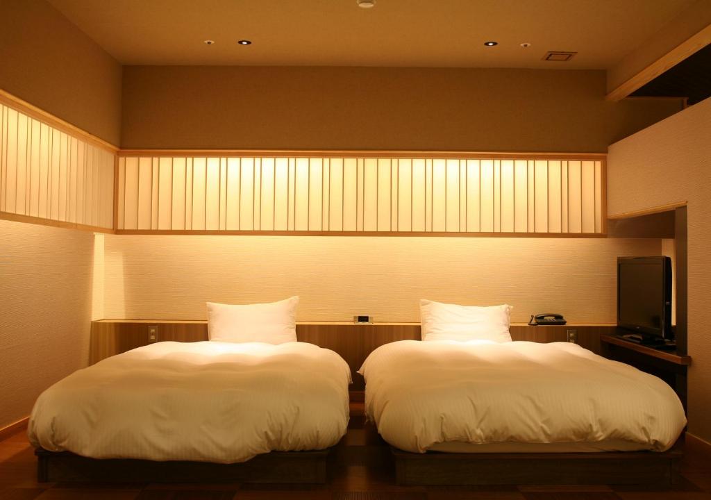 Postel nebo postele na pokoji v ubytování Hotel New Awaji