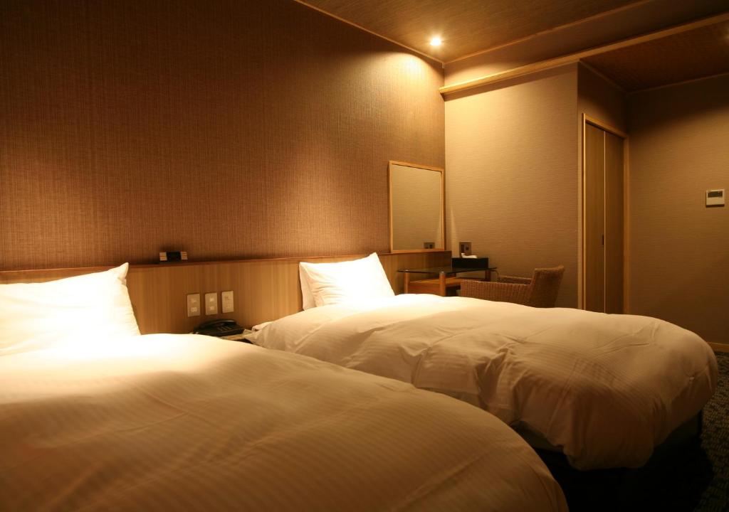 Postel nebo postele na pokoji v ubytování Hotel New Awaji