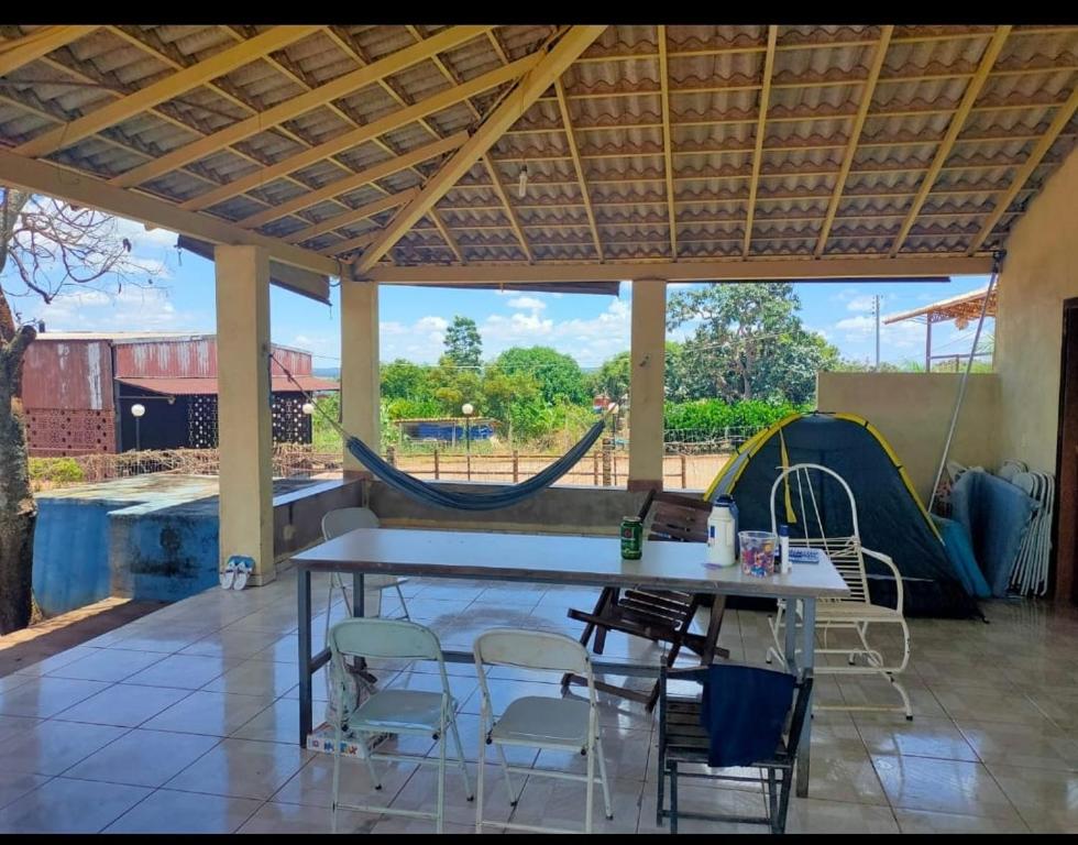 un patio con tavolo, sedie e scivolo di RANCHO PISCINA LAGO - Corumba 4 a Alexânia
