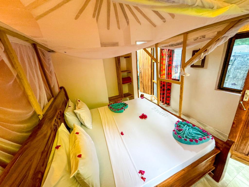 Postel nebo postele na pokoji v ubytování Sagando Bungalows Zanzibar