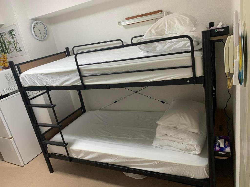 Postel nebo postele na pokoji v ubytování 新宿In