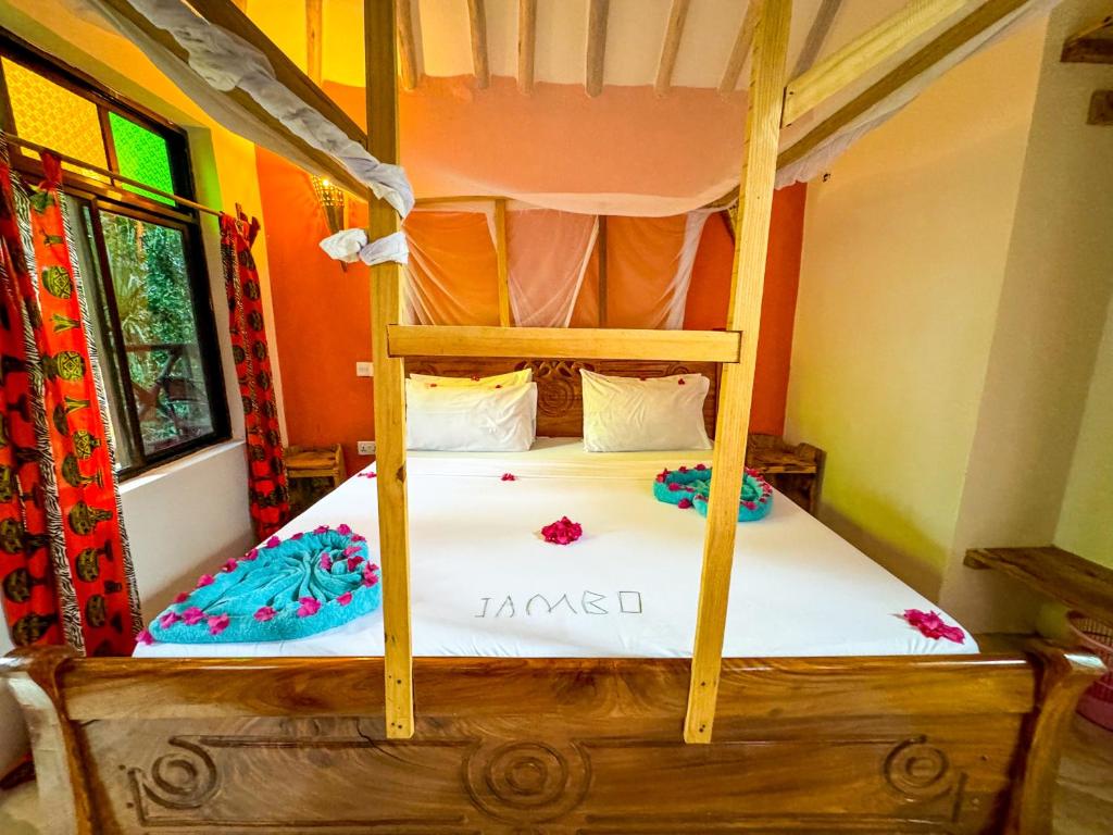 Postel nebo postele na pokoji v ubytování Sagando Bungalows Zanzibar
