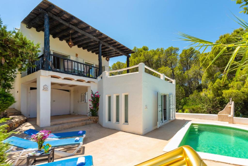 a villa with a swimming pool and a house at New! Villa Salada Sea Views in San Antonio