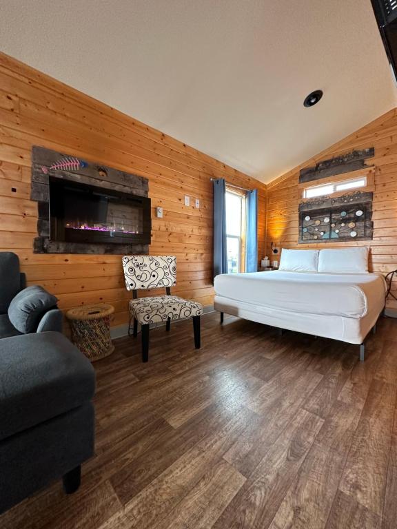 a bedroom with a large white bed and a couch at Westport Marina Cottages in Westport