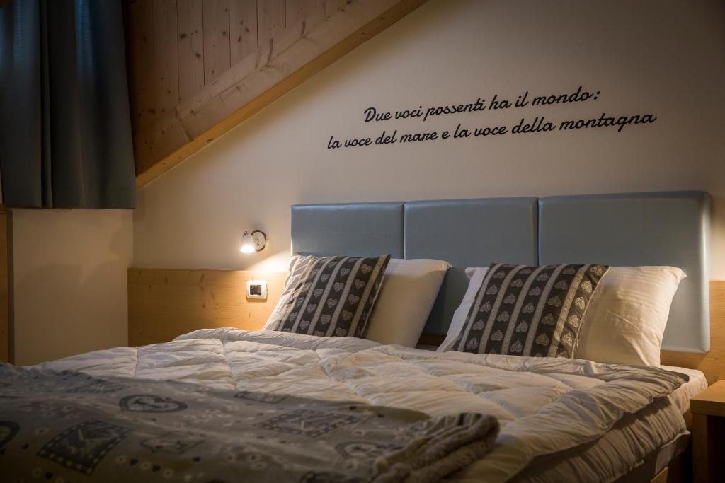 Postel nebo postele na pokoji v ubytování Aparthotel Dolomites Living&Relax