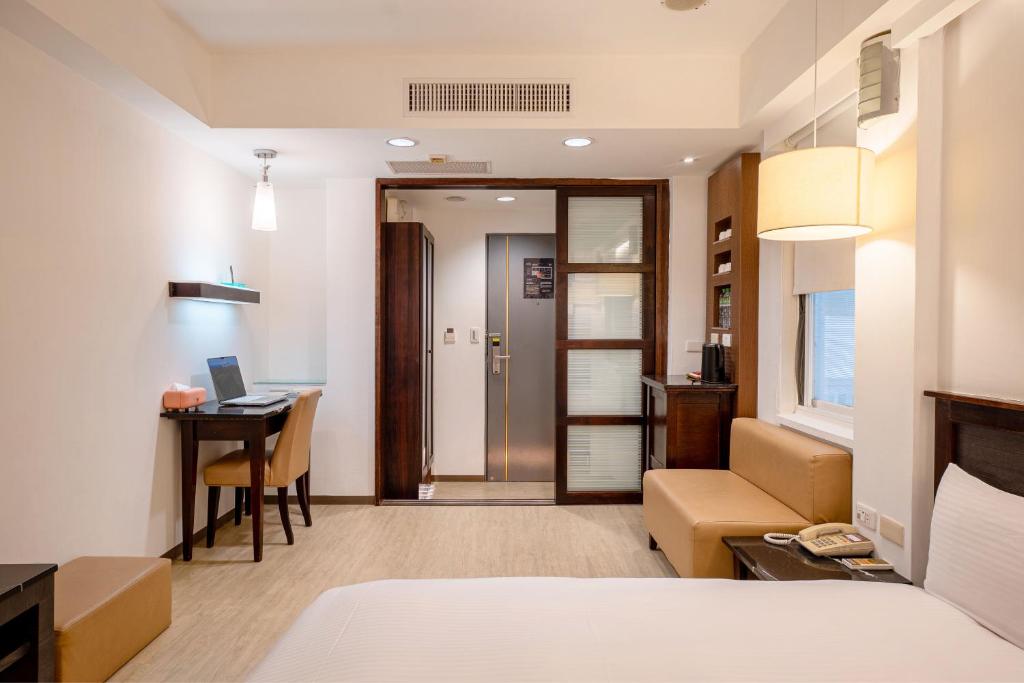 Postel nebo postele na pokoji v ubytování Guide Hotel Kaohsiung Shinkuchan