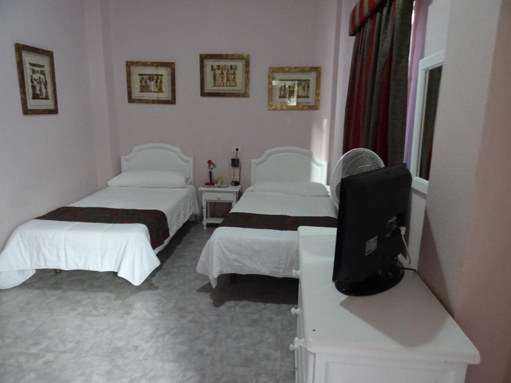 Postel nebo postele na pokoji v ubytování Hotel Tanausu
