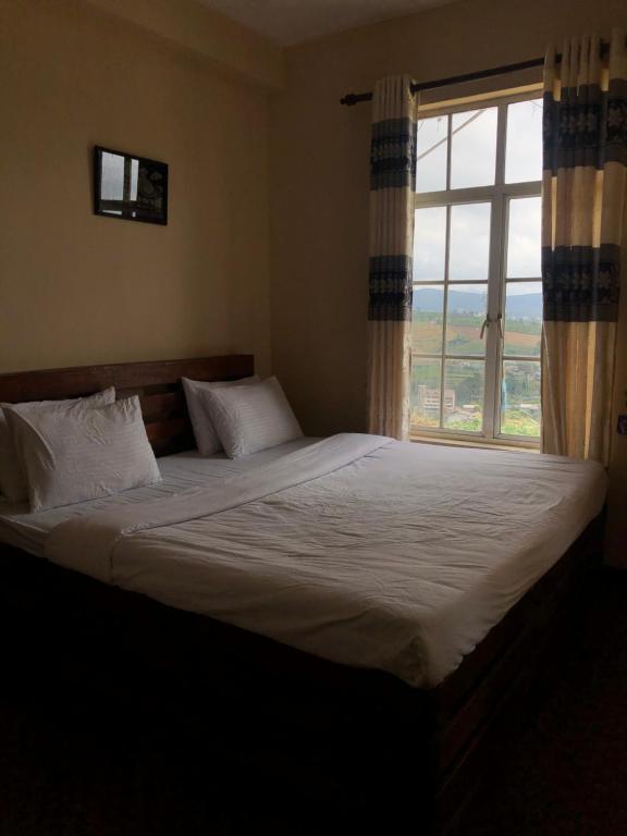 Postel nebo postele na pokoji v ubytování White Hill Villa