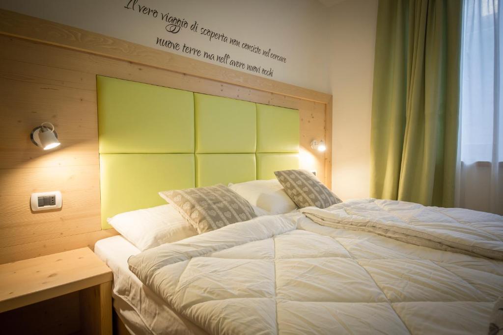 Postel nebo postele na pokoji v ubytování Aparthotel Dolomites Living&Relax