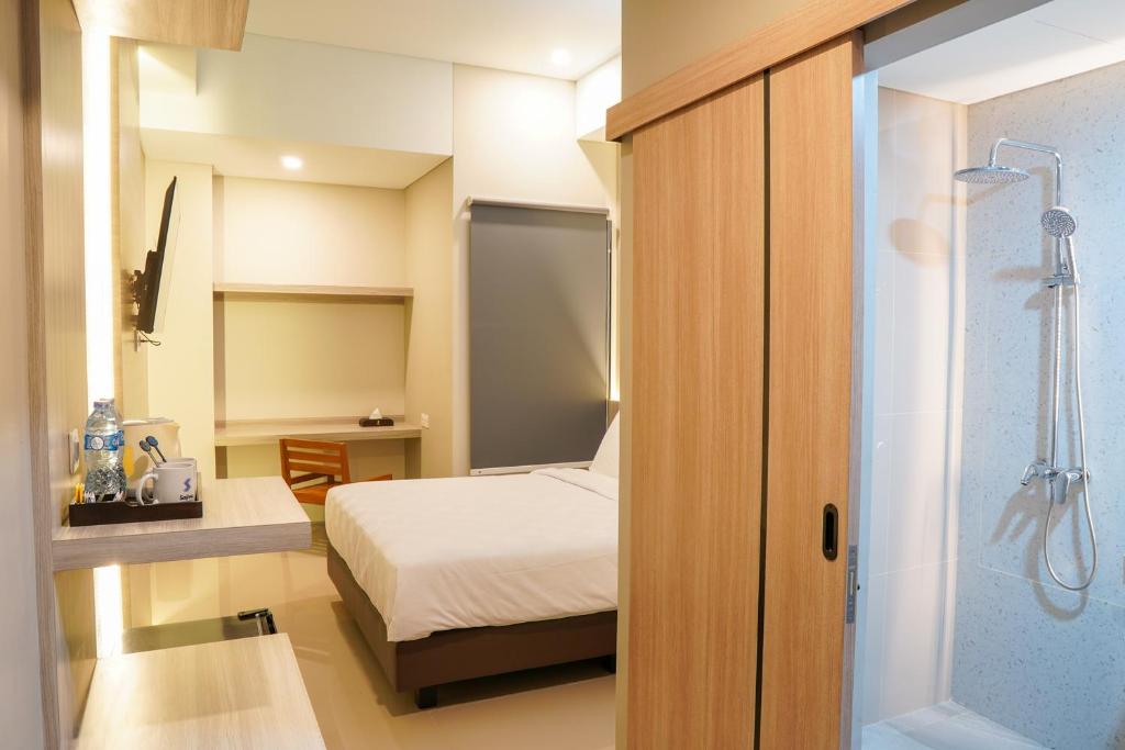 Voodi või voodid majutusasutuse Sajiwa Inn and Suite Hotel toas