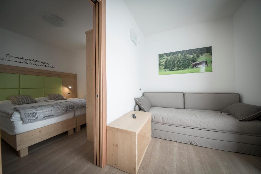 Postel nebo postele na pokoji v ubytování Aparthotel Dolomites Living&Relax