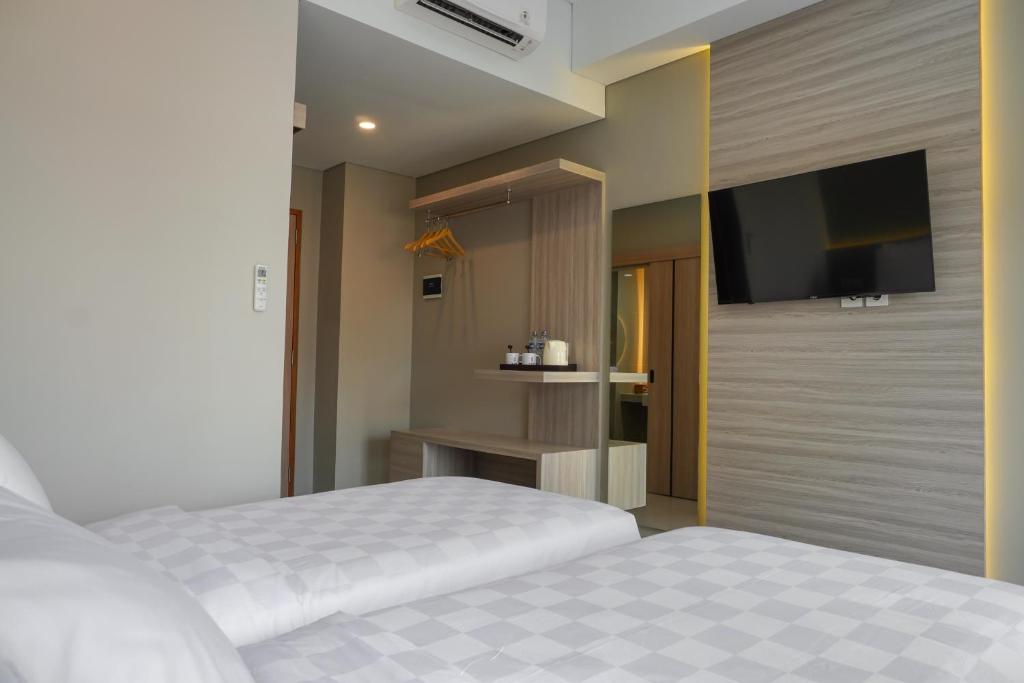 Voodi või voodid majutusasutuse Sajiwa Inn and Suite Hotel toas