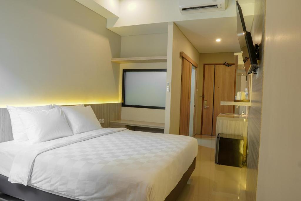 Voodi või voodid majutusasutuse Sajiwa Inn and Suite Hotel toas