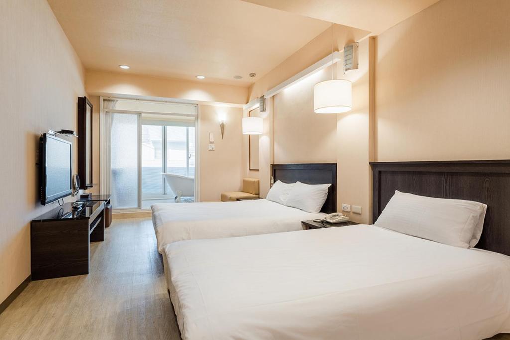 Postel nebo postele na pokoji v ubytování Guide Hotel Kaohsiung Shinkuchan