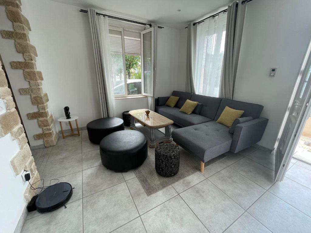 a living room with a couch and a table at Apparemment T2 en centre ville in Gournay-en-Bray