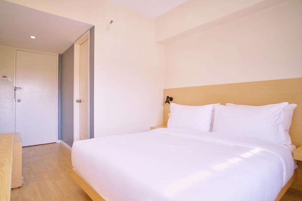 Postel nebo postele na pokoji v ubytování Bridge Hotel Express