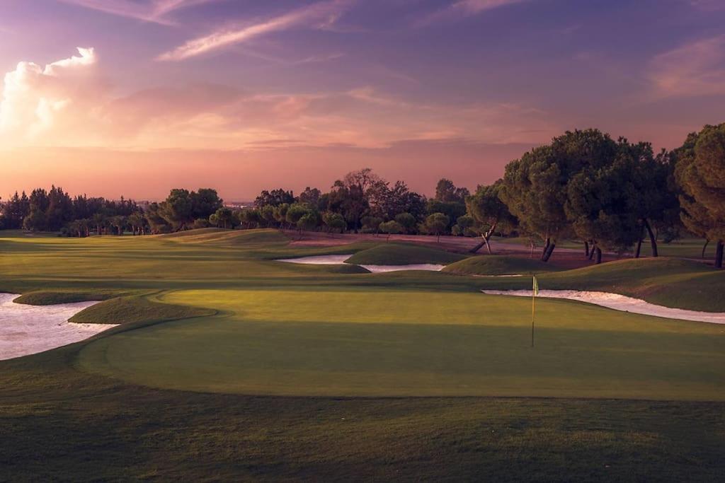 an aerial view of a golf course with a green at Anfitriones de Glamour - Albor de Sevilla in Montequinto