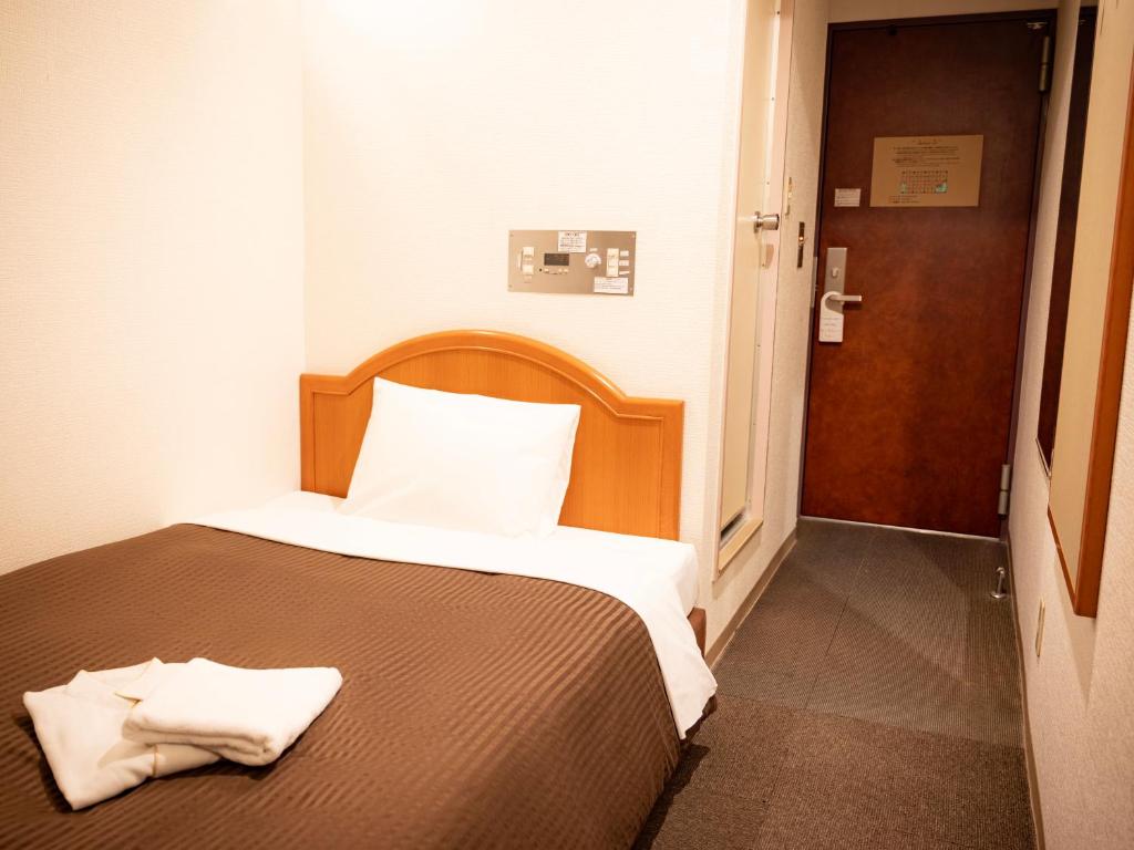 Postel nebo postele na pokoji v ubytování Numazu Grand Hotel