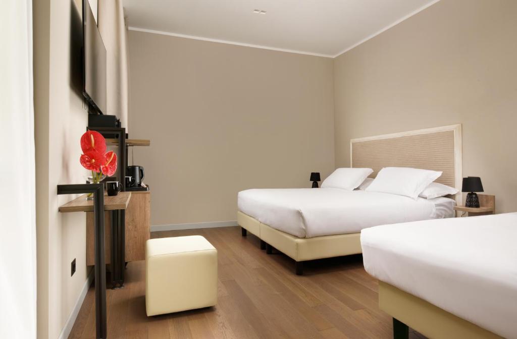 Postel nebo postele na pokoji v ubytování Essence Hotel