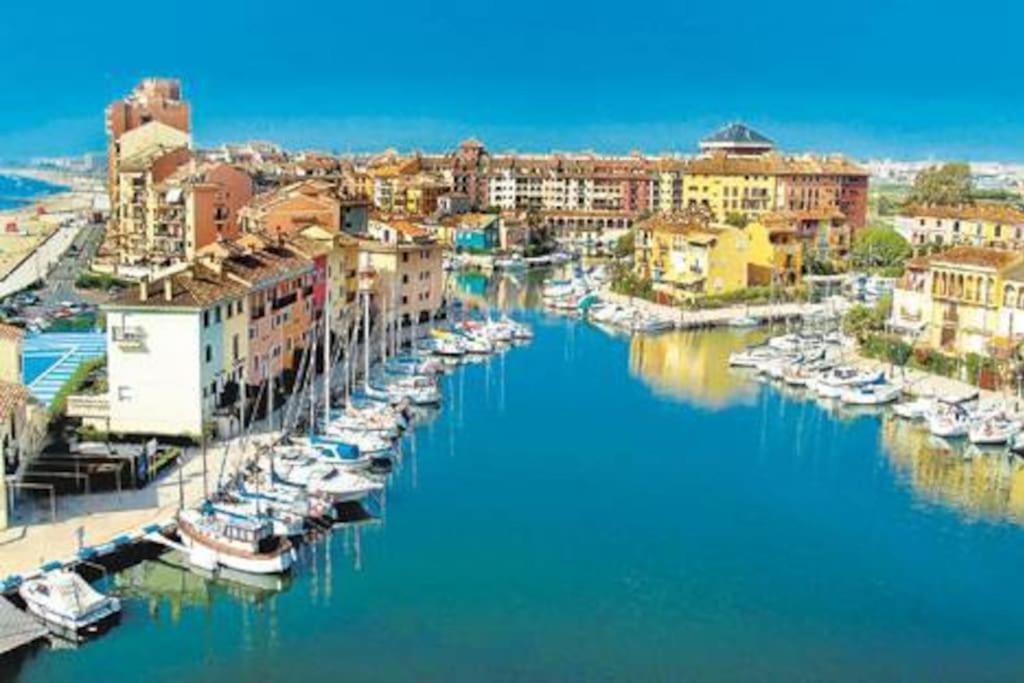 a group of boats are docked in a harbor at Little Venice apartment in Alboraya