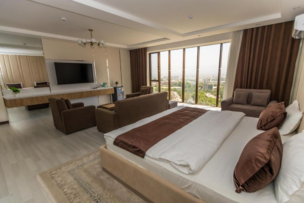 Postel nebo postele na pokoji v ubytování Firdavsi Hotel