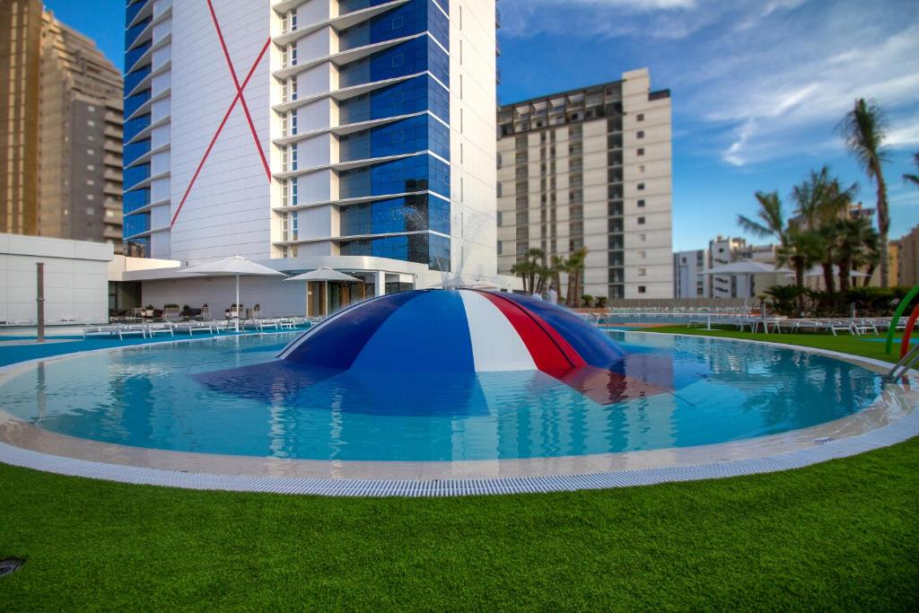 a large pool with a tent in the grass at ESTIMAR Calpe Suitopia in Calpe