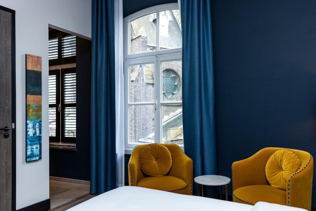 Postel nebo postele na pokoji v ubytování MERICI Hotel Sittard