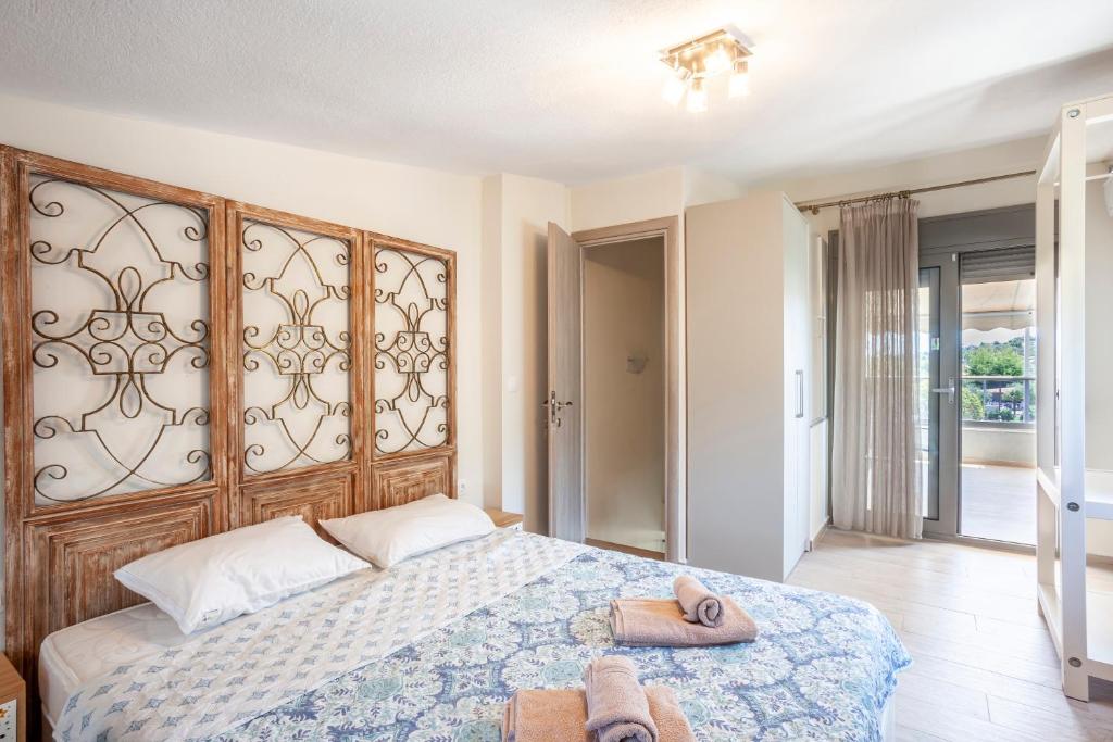 a bedroom with a large bed with two towels on it at Apartments Enastron 44 2 bedroom in Pefkochori