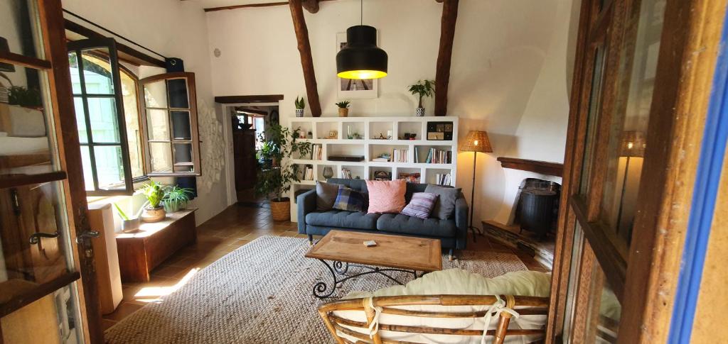 a living room with a couch and a table at Adorable maison cévenole in Bez-et-Esparon
