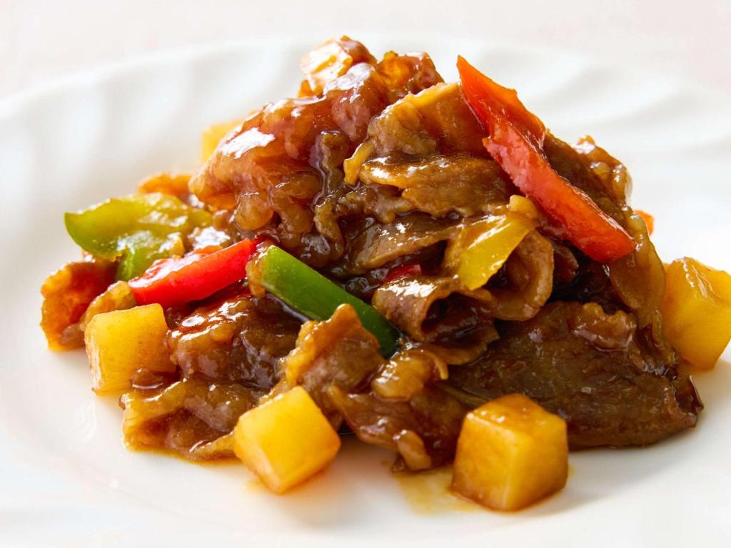 a white plate of food with meat and vegetables at Comfort Hotel Nara in Nara
