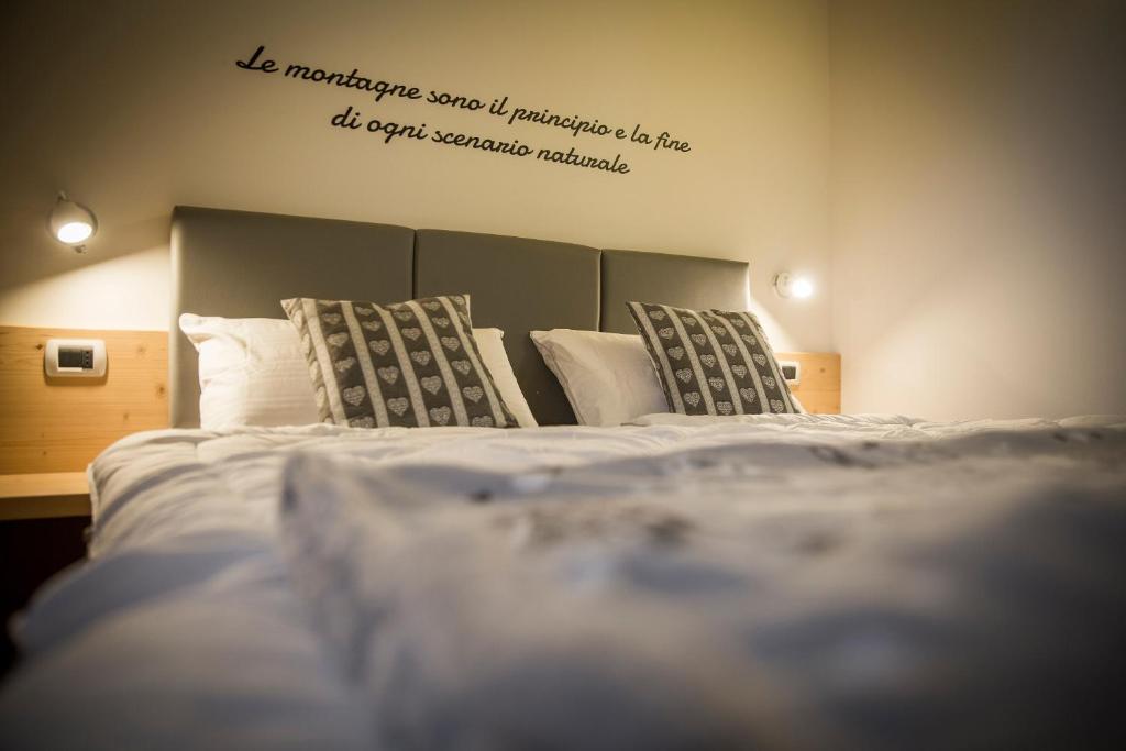 Postel nebo postele na pokoji v ubytování Aparthotel Dolomites Living&Relax