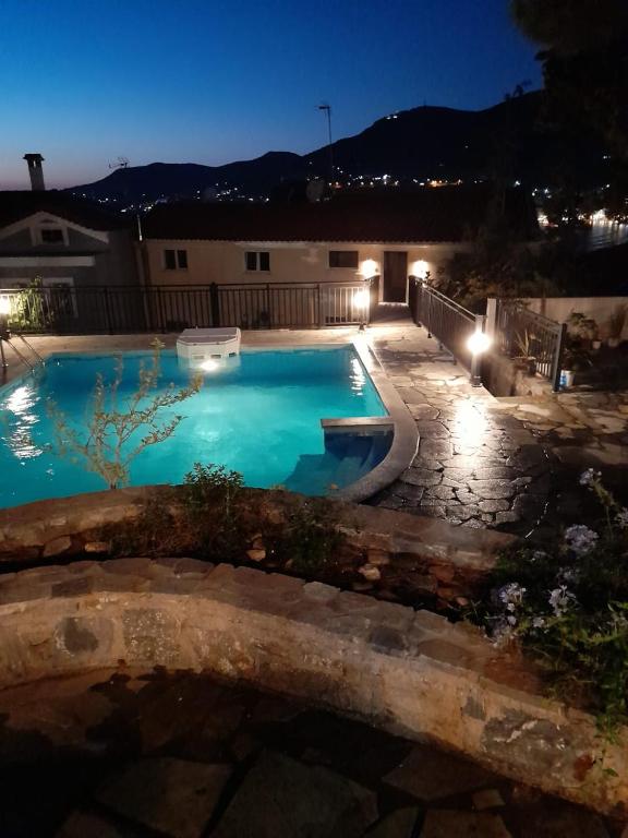 a swimming pool in a yard at night at Mondo Piccolino in Samos
