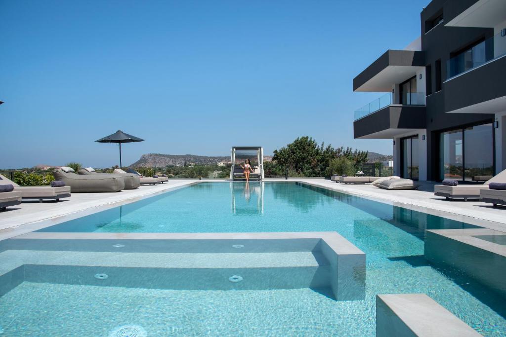 a swimming pool in the middle of a building at Omnia Luxury Villa, 100m2 Pool, Whirlpool & Gym, By ThinkVilla in Prínos