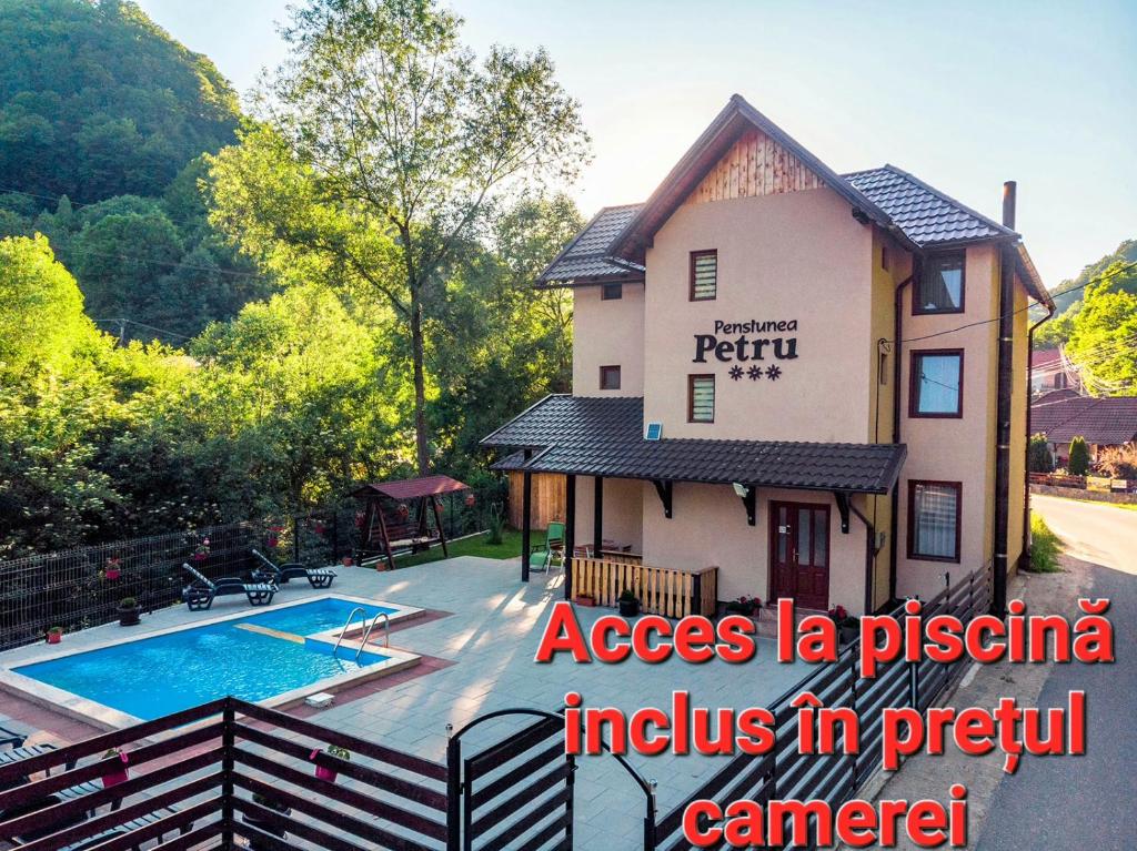 a villa with a swimming pool and a fence at Pensiunea Petru in Şugag