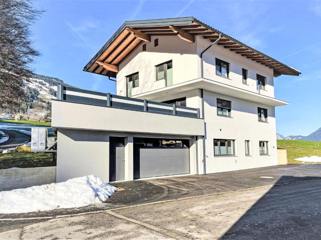 a white house with a brown roof at Apartment Ferienwohnung Selina by Interhome in Fügenberg